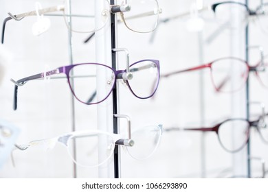 Sideview Of Fashionable Optical Eyeglasses, Hanging On Transparent Set With Other Glasses. Vision Improving And Protecting. Appointing After Medical Examination.