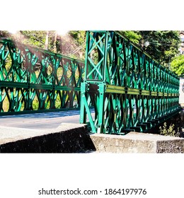 A Sideview Of A Green Bridge