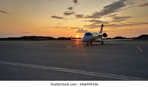 Side-view Of Luxury Private Jet On Tarmac With Huge Copy Space Above.