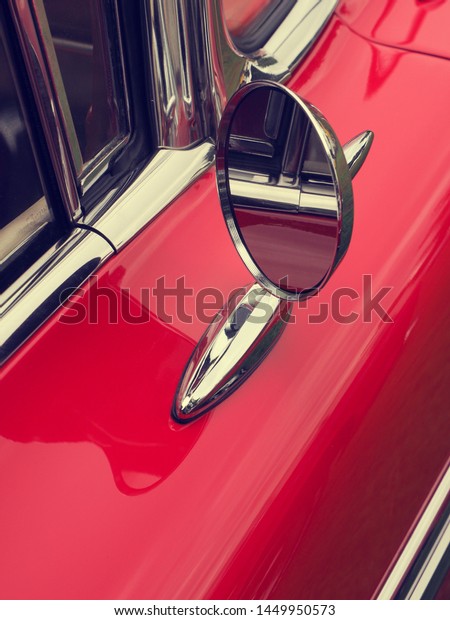 Sideview mirror of an old vintage car,\
conceptual vintage background with space for\
text