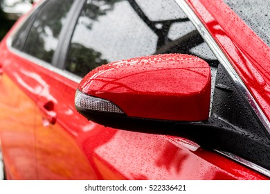 Sideview  Mirror Of Red Car While Raining