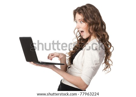 Side-view portrait of young female having seen something funny on laptop, isolated on white background