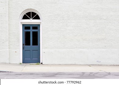 Sidewalk By Brick Wall & Door