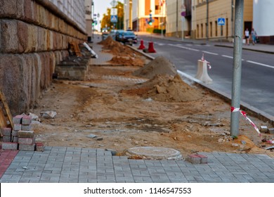 Sidewalk construction, laying paving slabs. Restoration of footpath. Building sidewalk