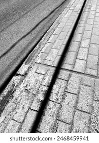 A sidewalk of interblocks with casting shadows