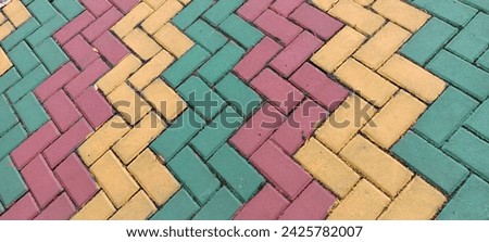 The sidewalk paving blocks are neatly arranged and painted in beautiful colorful colors