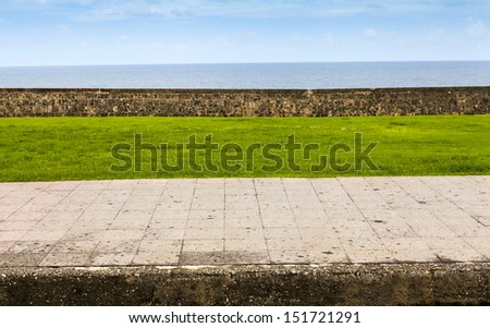 Sidewalk side view with ocean in background