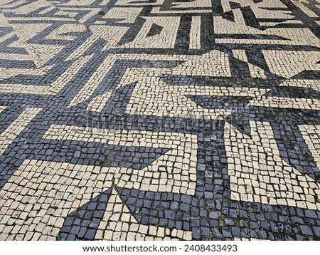 Sidewalks with Portuguese stones basalt designs on the sidewalks made of stones