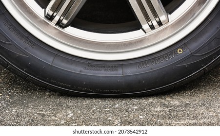 Sidewall Of The  Car Tire With A Low Tire Pressure On The Road,close Up