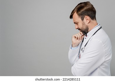 Sideways Pensive Minded Male Doctor Man Wearing White Medical Gown Suit Stethoscope Work In Hospital Prop Up Chin Isolated On Plain Grey Color Background Studio Portrait. Healthcare Medicine Concept