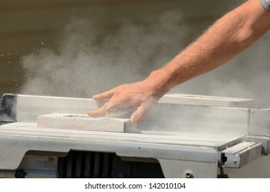 A Siding Contractor Cuts Blocks For Electrical Outlets At A Commercial Residential Development