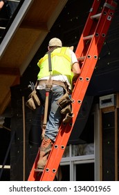 Siding Contractor Placing Trim Boards Up On A New Commercial Residential Development Building