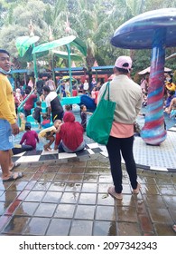 Sidoarjo, Indonesia - December 12, 2021 : Bustling Atmosphere At The Public Swimming Pool During The Holiday Weekend