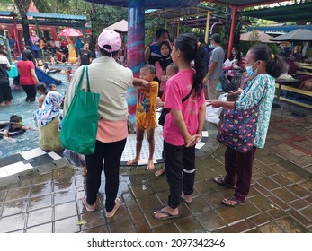 Sidoarjo, Indonesia - December 12, 2021 : Bustling Atmosphere At The Public Swimming Pool During The Holiday Weekend