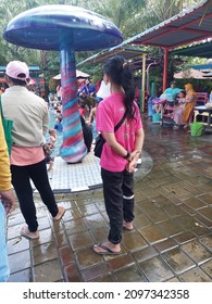 Sidoarjo, Indonesia - December 12, 2021 : Bustling Atmosphere At The Public Swimming Pool During The Holiday Weekend