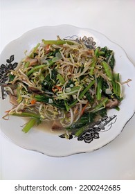 Sidoarjo, Indonesia - September 11, 2022 : Sauteed Mustard Greens And Bean Sprouts On White Background For Breakfast.