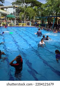 Sidoarjo, Indonesia - September 18, 2022 : Public Swimming Pool Crowded With Visitors