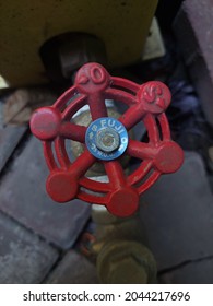 Sidoarjo, Indonesia - September 19, 2021 : Red Round Faucet Knob.