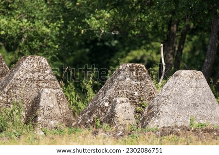 The Siegfried Line. A system of strongpoints  in Germany also known as the Westwall. German defensive line built of concrete and stone. Forest background.  Large cement antitank obstructions.