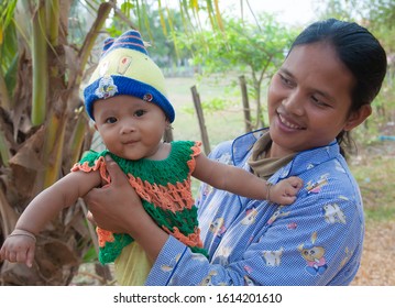 Siem Reap, Cambodia - 2/28/2011: A Cambodian mother showing off her infant daughter.