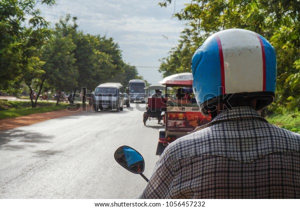 Siem Reap, Cambodia -\
August 3th, 2016: The tuk-tuk car driver, fast, not expensive, and\
convenient. On the way to the famous landmarks in Siem Reap, such\
as angkor-wat.