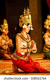SIEM REAP, CAMBODIA - DECEMBER 28, 2008: 3 kneeling Khmer classical dancers performing in traditional costume December 28, 2008 in Siem Reap, Cambodia.Angkor Wat is the most visited place in Cambodia.