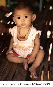 Siem Reap, Cambodia - December 9th 2018: Portrait of a young girl in her stilted house