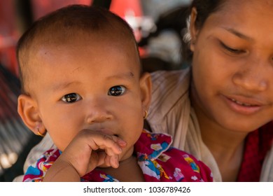 Siem Reap, Siem Reap Province, Cambodia - November 27 2015 : Portrait of a young baby in colourful pyjamas in a village on Highway 6 close to Siem Reap