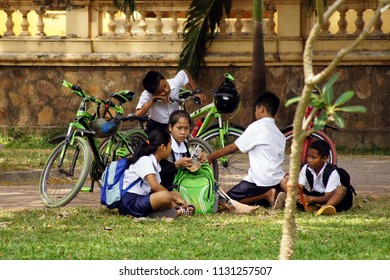 Siem Reap/Cambodia - 02.06.2017: Schoolchildren Sit On The Grass And Talk About Something In Yhe Park