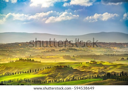 Siena city panoramic skyline, countryside and rolling hills in a misty day. Tuscany, Italy, Europe.