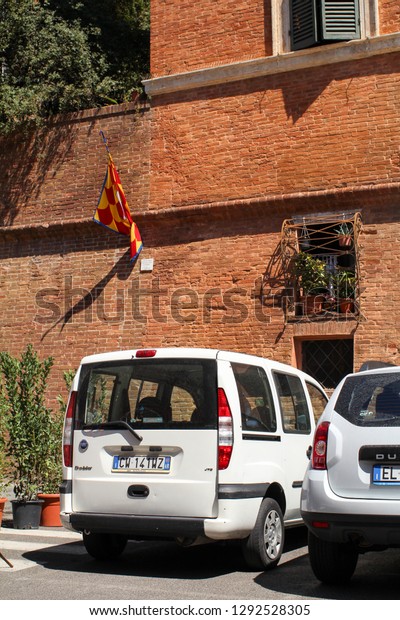 Siena, Italy - 08/19/2012: The cars parked in the\
center of an old town.