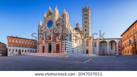 Siena, Italy. Beautiful view of facade and campanile of Siena Cathedral, Duomo di Siena at sunrise, Siena, Tuscany.