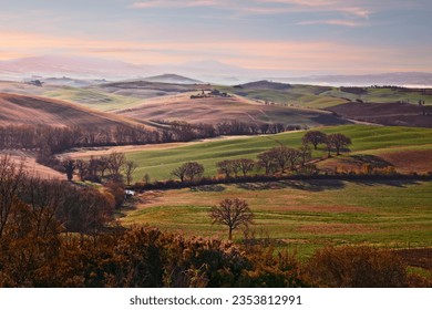 Siena, Tuscany, Italy: landscape at sunrise of the Val d'Orcia countryside and the picturesque colorful hills
				
				