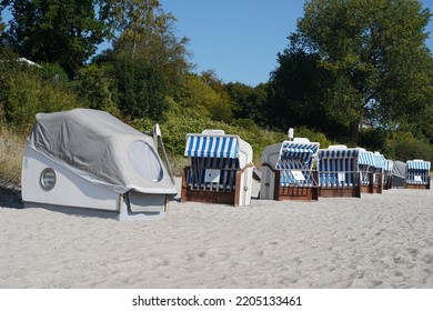 Sierksdorf, Germany - September 22, 2022: Traditional German Beach Chairs And New Sleeping Beach Chairs On A Sandy Beach At The Baltic Coast In The Bay Of Lübeck