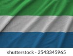 Sierra Leone flag depicted on folded wavy fabric of old cloth close up