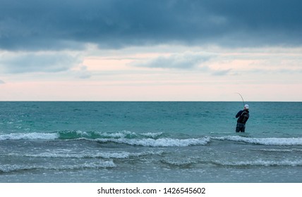 Siesta Key, FL - March 26, 2019:  Man Catching A Fish Off The Florida Gulf Coast.  With Over 1000 Species Of Fish, The West Coast Of Florida Offers Some Of The Best Fishing In The United States.