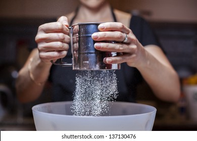Sifting flour into a bowl/ Sifting flour