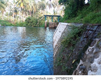 A Sight Of A Lakeside With Muddy Wall And Deep Water