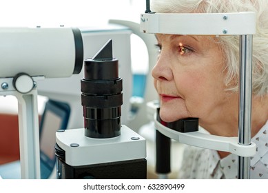 Sight of old woman verifying by apparatus