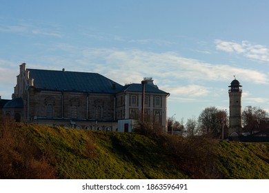 Sights And Views Of Grodno. Belarus. The Buildings Of The Old Synagogue And The Fire Tower On A High Hill.