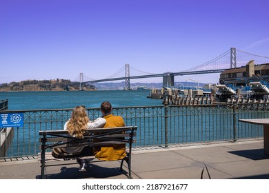 Sightseeing at Oakland Bay Bridge, Yerba Buena island. This is iconic view from the Pier at the downtown San Francisco, California. There is ferry boat transporting tourist and passengers to both side