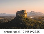 Sigiriya rock also known as Lion Rock at golden light of sunset. Beautiful landscape in Sri lanka.
