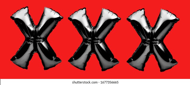 sign for adult content material. Letters X made of black inflatable helium balloon on red background. Porn, adult content only. Online porn concept. Sex sites