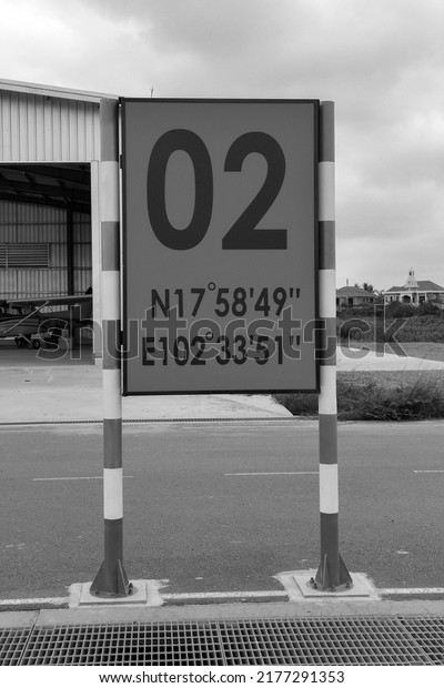 A sign at an airport in a city.  At the base of\
aircraft and roads.  Drawings.  Posters on the side of the road \
back and withe