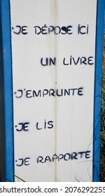 A sign alongside a free book depository stating the following "I put a book here, I borrow, I read, I bring back" on Omaha beach, Calvados, Normandy, France, Europe on Saturday, 16th, October, 2021