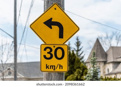 A Sign With An Arrow Pointing Left And A 30 Kilometre Per Hour.
