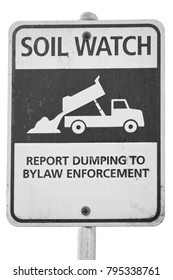 A Sign Asks Civilians To Report To By Law Enforcement Officers If They Observe Someone Illegally Dumping Soil. 