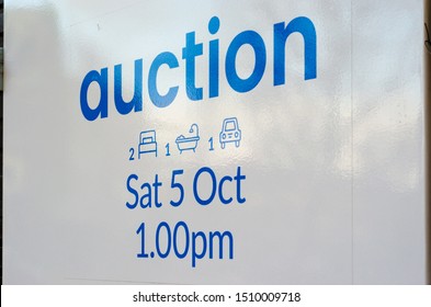 Sign Of Auction For A Residential Property. The Sign Indicates The Property Has 2 Bedrooms, 1 Bathroom And 1 Car Space, And The Upcoming Scheduled Auction Date And Time. Melbourne, VIC Australia.