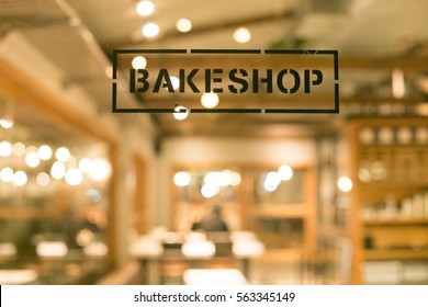 A sign of bakery shop with a blurry interior background - Shutterstock ID 563345149