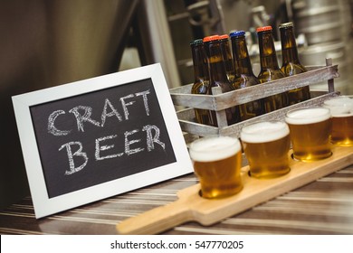 Sign Board With Beer Samples On Table At Brewery